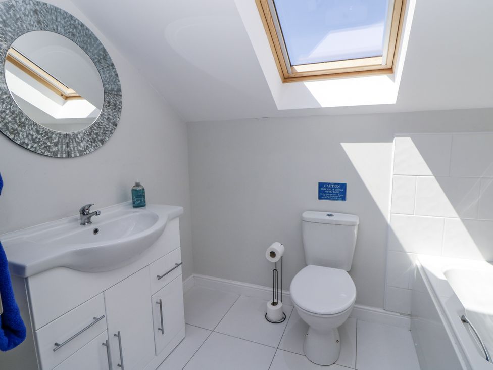 A bathroom with a sink and a toilet at Little Penrhosgoch Barn Llandrindod Wells