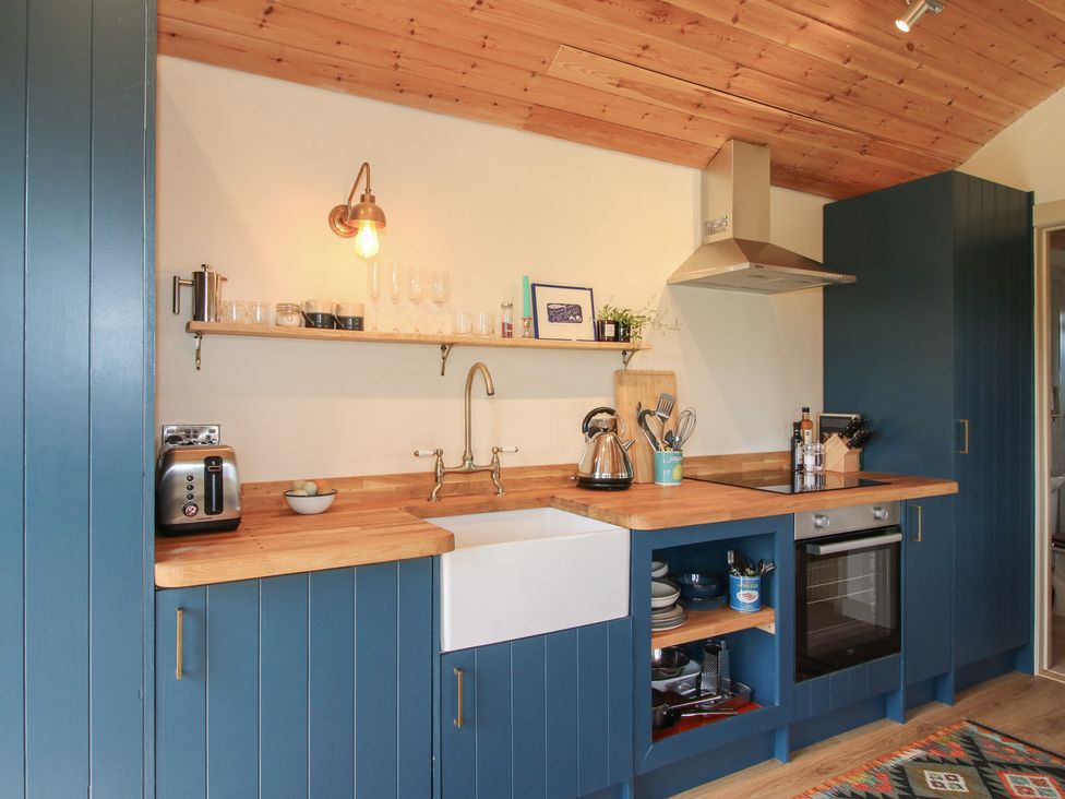 A kitchen with a sink, kettle, and toaster at Owl's Hollow Chapel Lawn near Clun