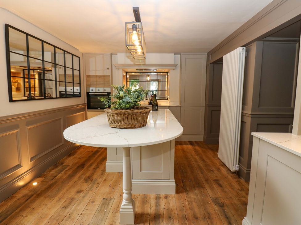 A kitchen with an island and basket at White House in Durham