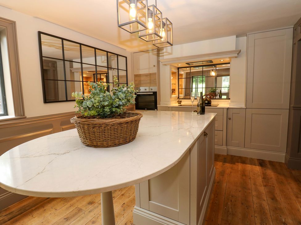 A kitchen with an island and cabinets at White House in Durham