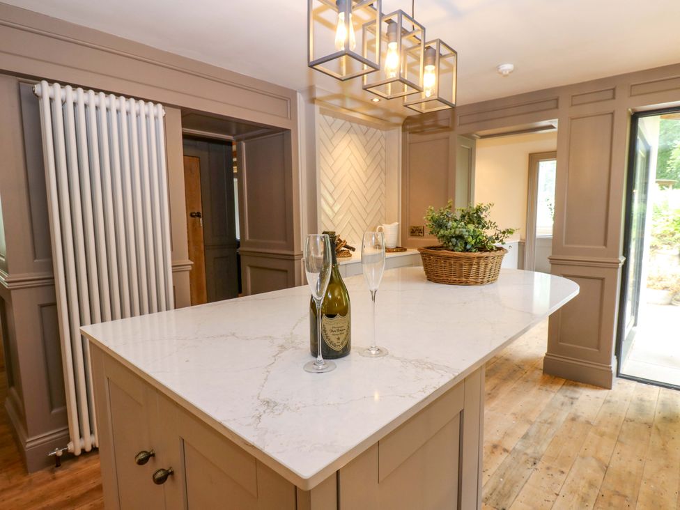 A kitchen with an island and wine at White House in Durham