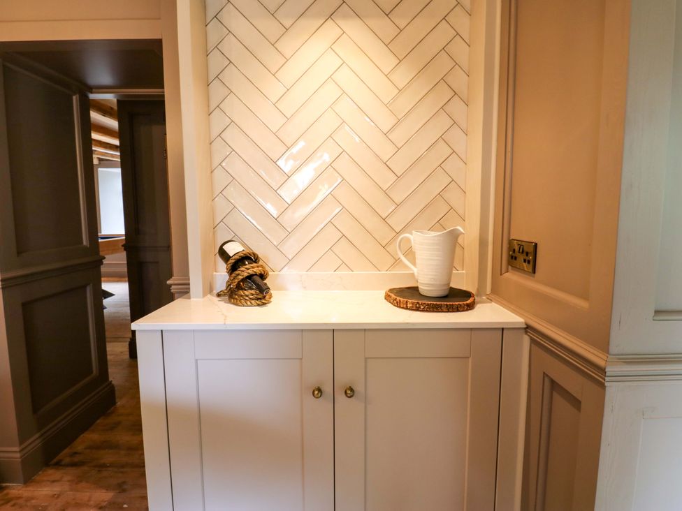 A kitchen area with a cupboard and pitcher at White House in Durham