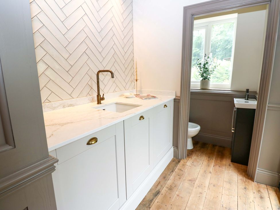 A bathroom with a sink and toilet at White House in Durham