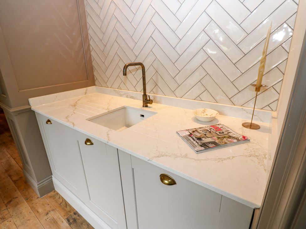 A kitchen countertop with a sink and faucet at White House in Durham