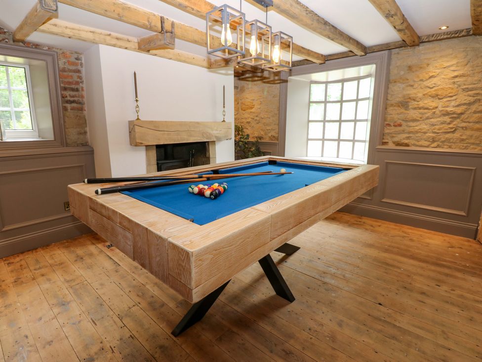 A snug with a pool table and a fireplace at White House in Durham
