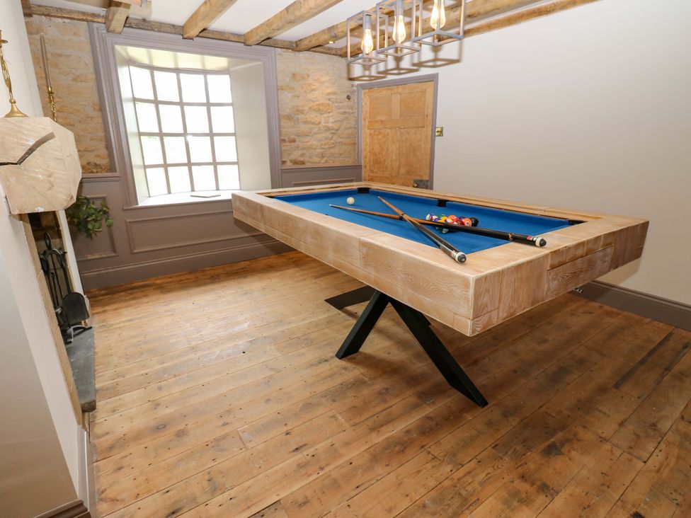 A game room with a billiards table and window at White House in Durham