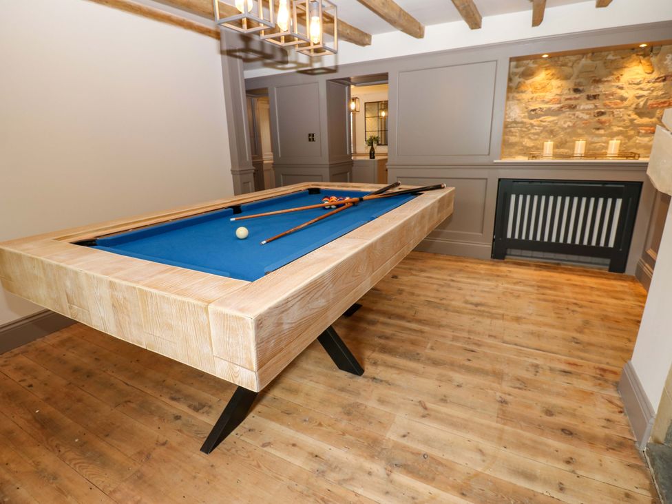 A snug with a pool table and cue sticks at White House in Durham