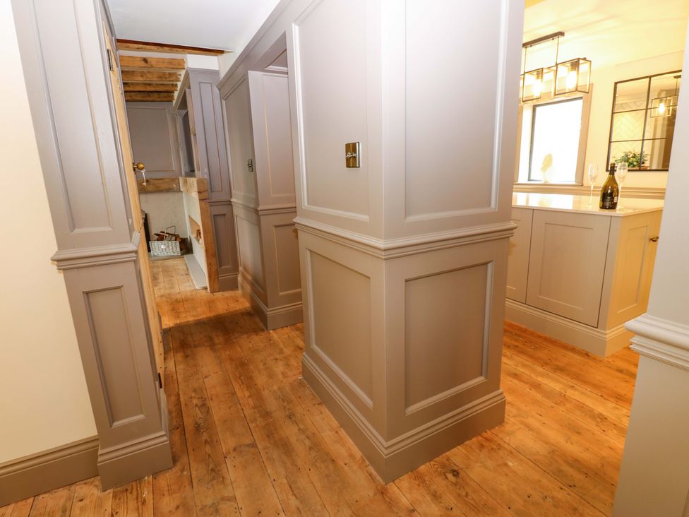 A hallway with cabinets and a staircase at White House in Durham