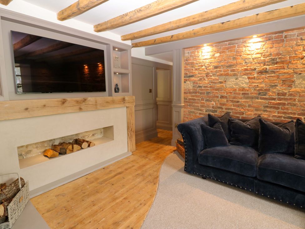 A living room with a television and sofa at White House in Durham