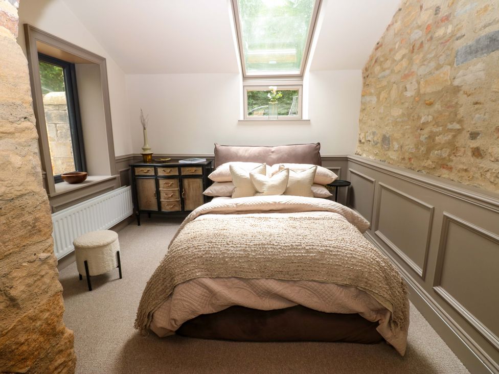 A bedroom with a bed and storage cabinet at White House in Durham