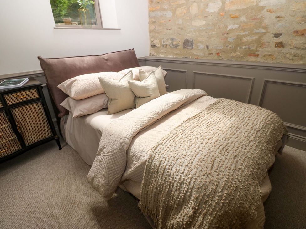A bedroom with a bed and nightstand at White House in Durham