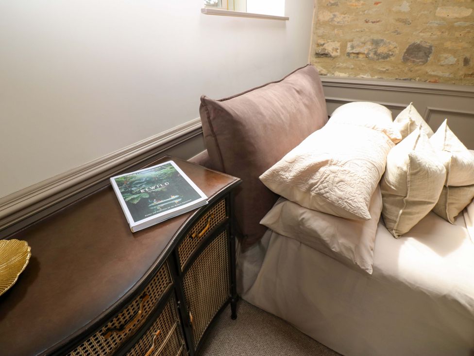 A bedroom with a bed and cushions at White House in Durham