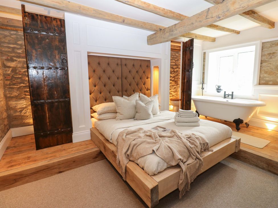 A bedroom with a bed and bathtub at White House in Durham