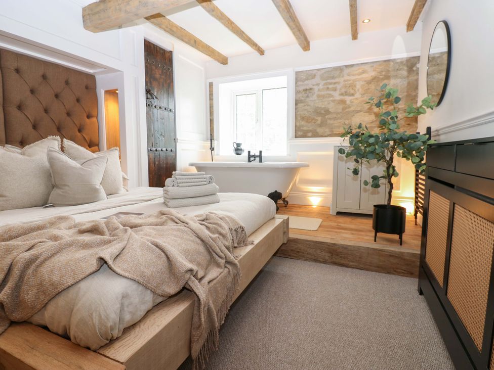 A bedroom with a bed and a bathtub at White House in Durham