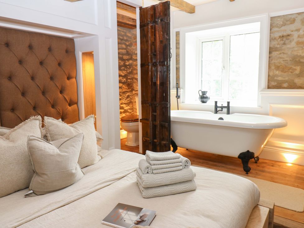 A bedroom with a bed and bathtub at White House in Durham