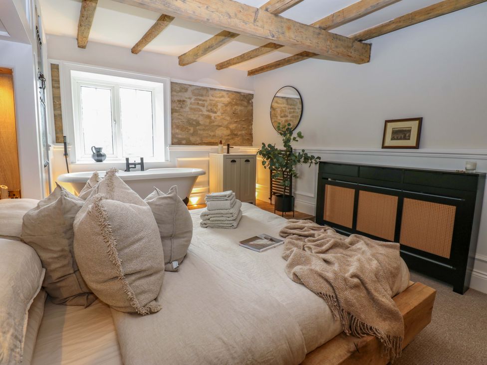 A bedroom with a bed and bathtub at White House in Durham