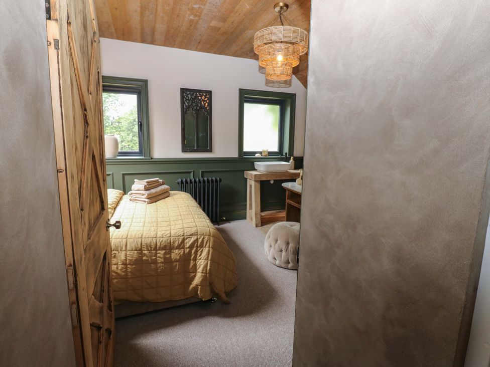 A bedroom with a bed and a sink at White House in Durham