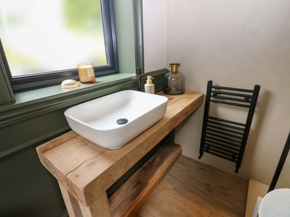 A bathroom with a sink and wooden countertop at White House in Durham