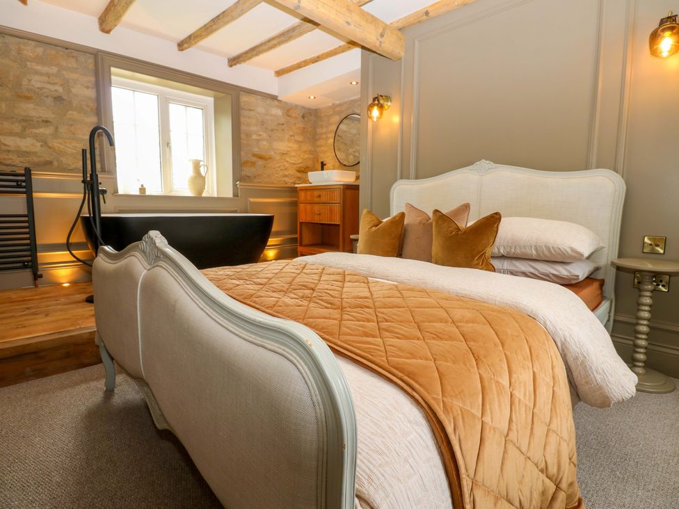 A bedroom with a bed and a bathtub at White House in Durham