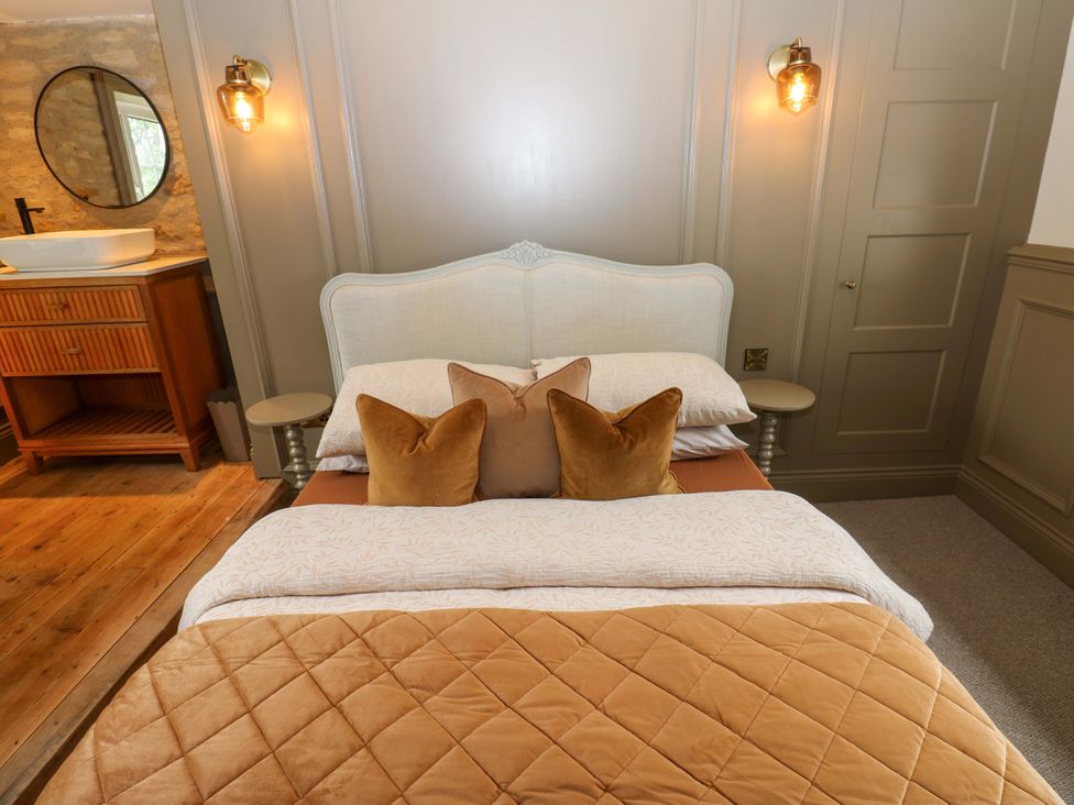 A bedroom with a bed and adjacent sink at White House in Durham
