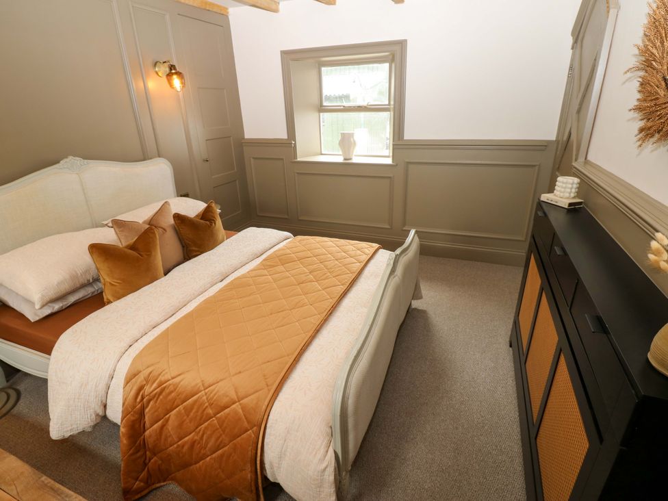 A bedroom with a bed and dresser at White House in Durham