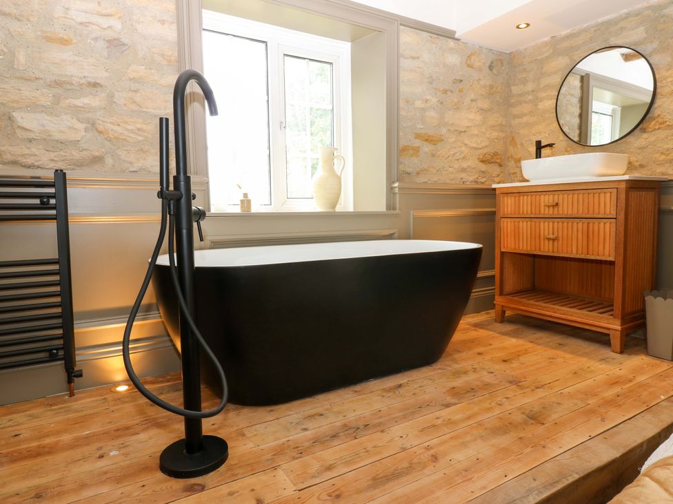 A bathroom with a bathtub and sink at White House in Durham