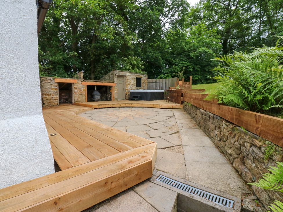 An outdoor area with decking and stone path at White House in Durham