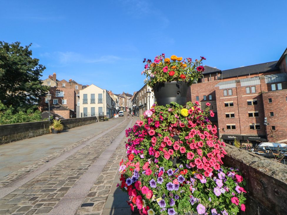 A view of a street with flowers on a planter at White House in Durham
