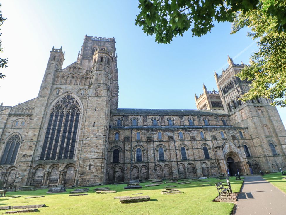 A cathedral with towers and a grassy area at White House in Durham