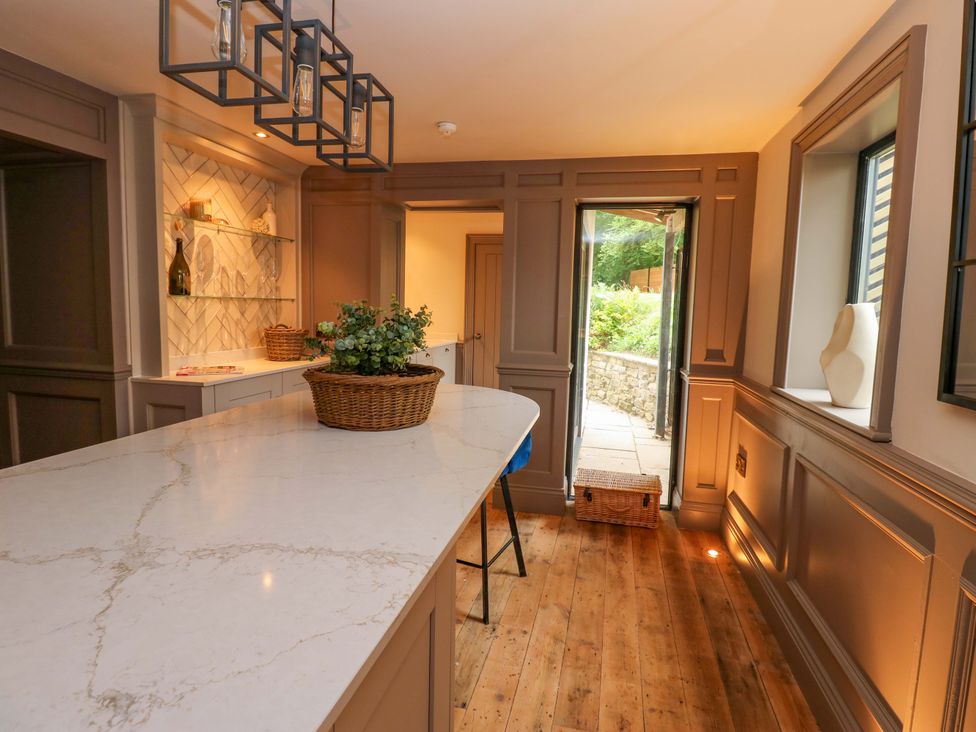 A kitchen with a large island and shelving at White House in Durham