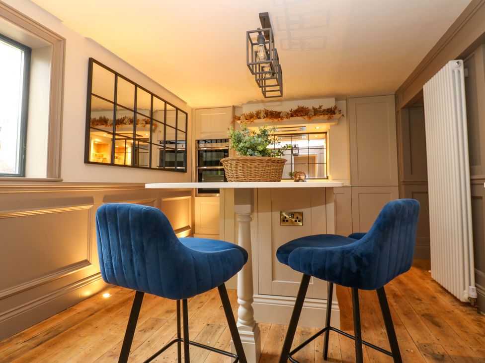 A kitchen with bar stools and a table at White House in Durham