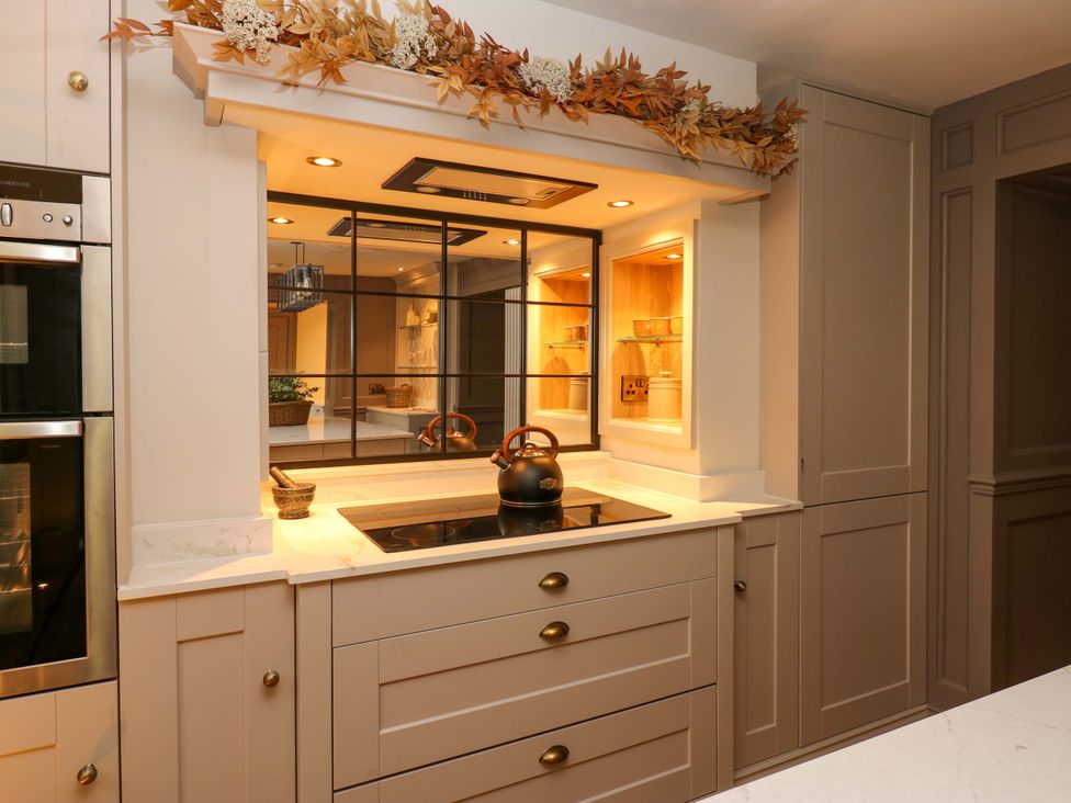 A kitchen with a stove and coffee kettle at White House in Durham
