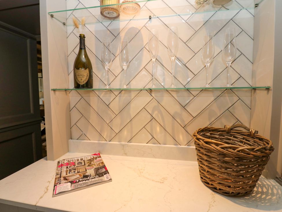 A kitchen display with a champagne bottle and glasses at White House in Durham