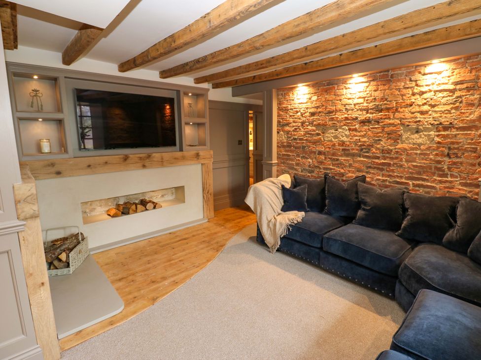 A living room with a sofa and television at White House in Durham
