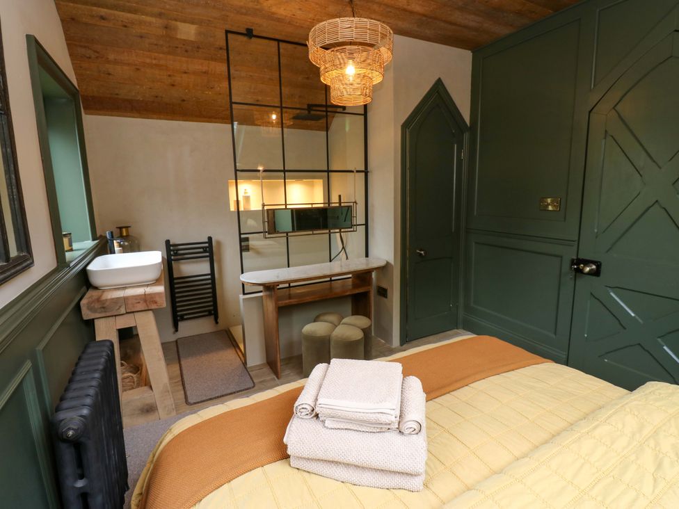 A bedroom with a bed, towels, and a sink at White House in Durham