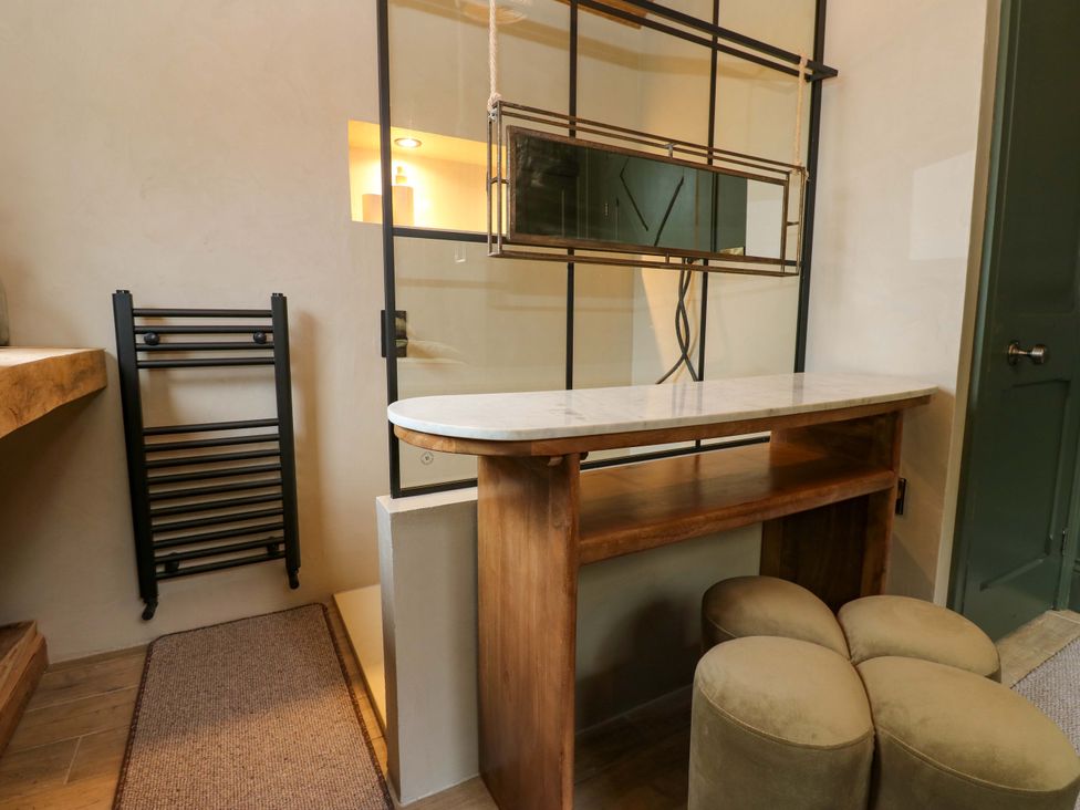 A bathroom with a bar counter and stools at White House in Durham