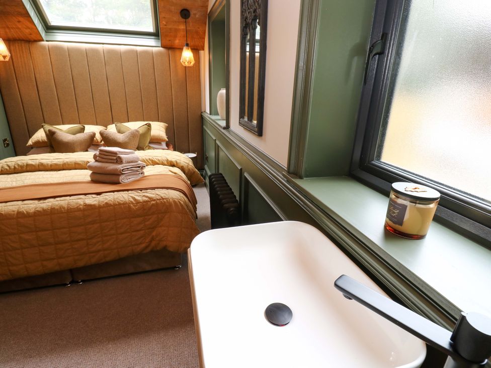 A bedroom with a bed and sink at the White House in Durham