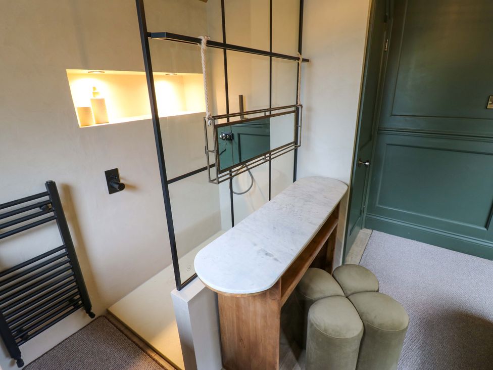 A bathroom with a counter and stools at White House in Durham