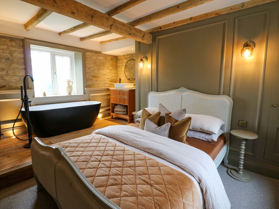 A bedroom with a bed and a bath tub at White House in Durham