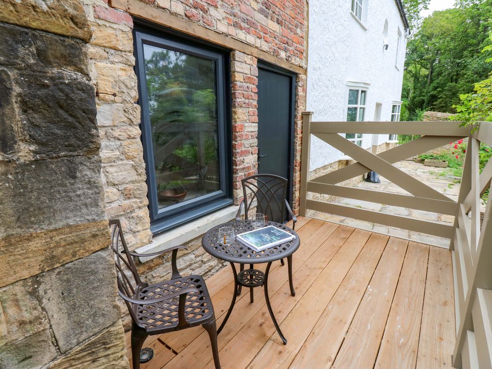 A balcony with table and chairs at White House in Durham