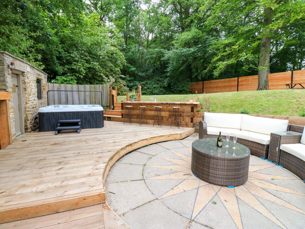 An outdoor area with a hot tub and seating at White House in Durham