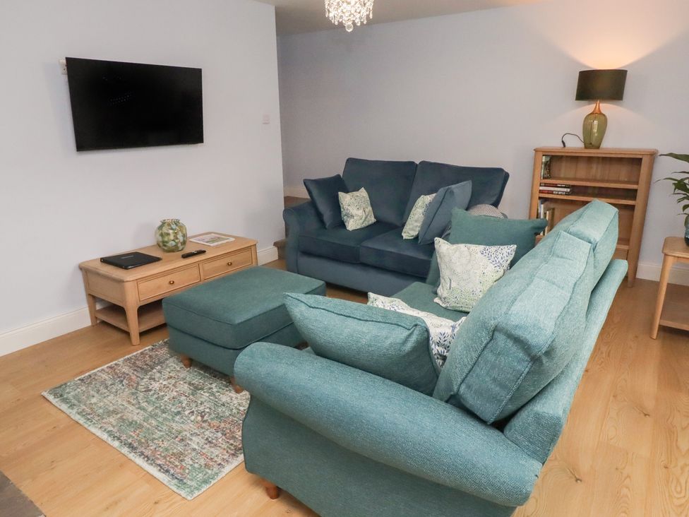 A living room with a sofa and coffee table at Linn Cottage in Hexham
