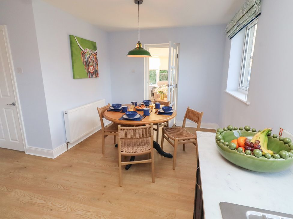 A dining room with a table and chairs at Linn Cottage in Hexham