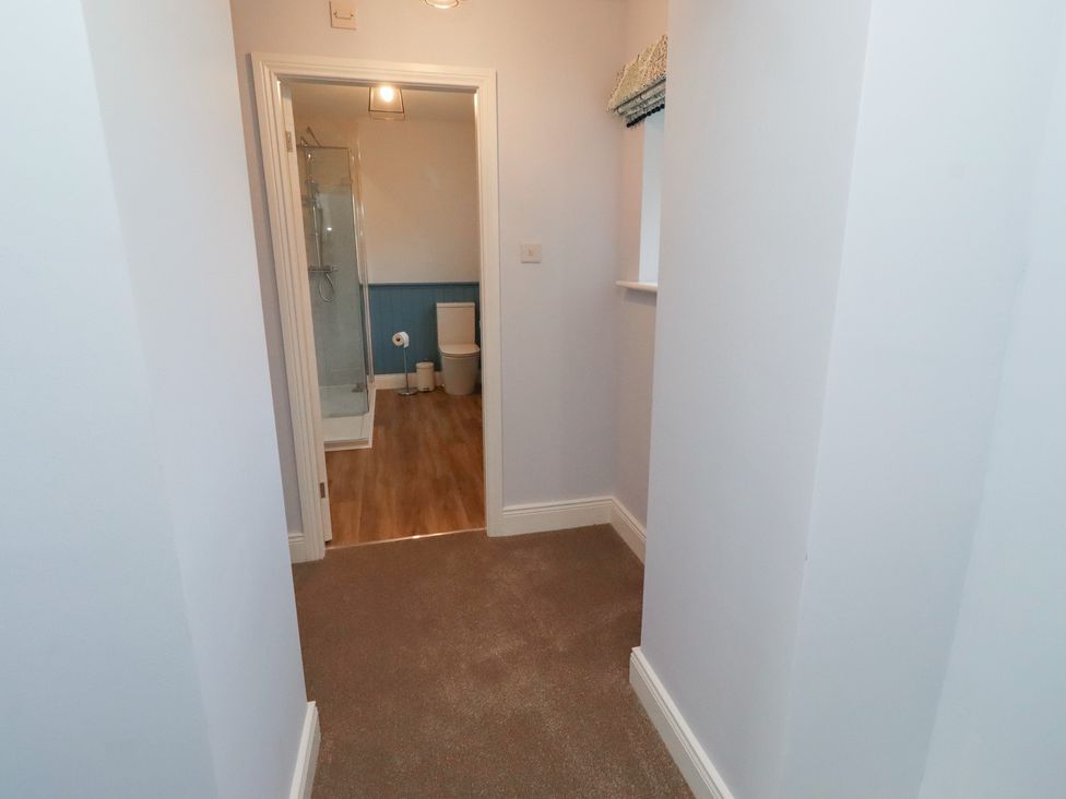 A bathroom with a shower and toilet at Linn Cottage in Hexham