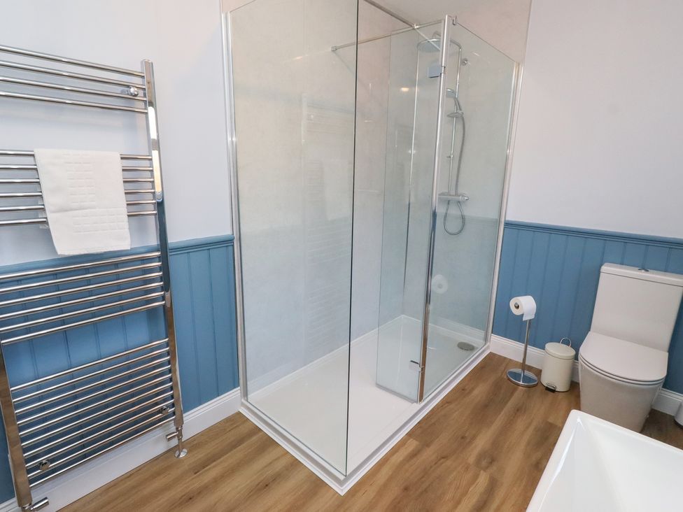 A bathroom with a shower and toilet at Linn Cottage in Hexham
