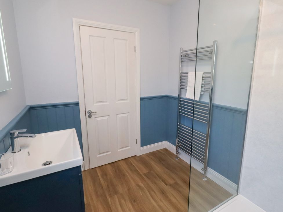 A bathroom with a sink and towel rail at Linn Cottage in Hexham