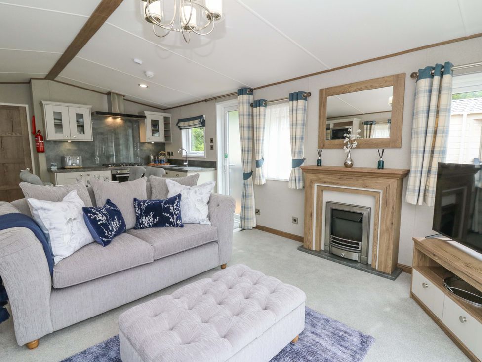 A living room with a sofa and television at The Beaumont No 34 in New Quay