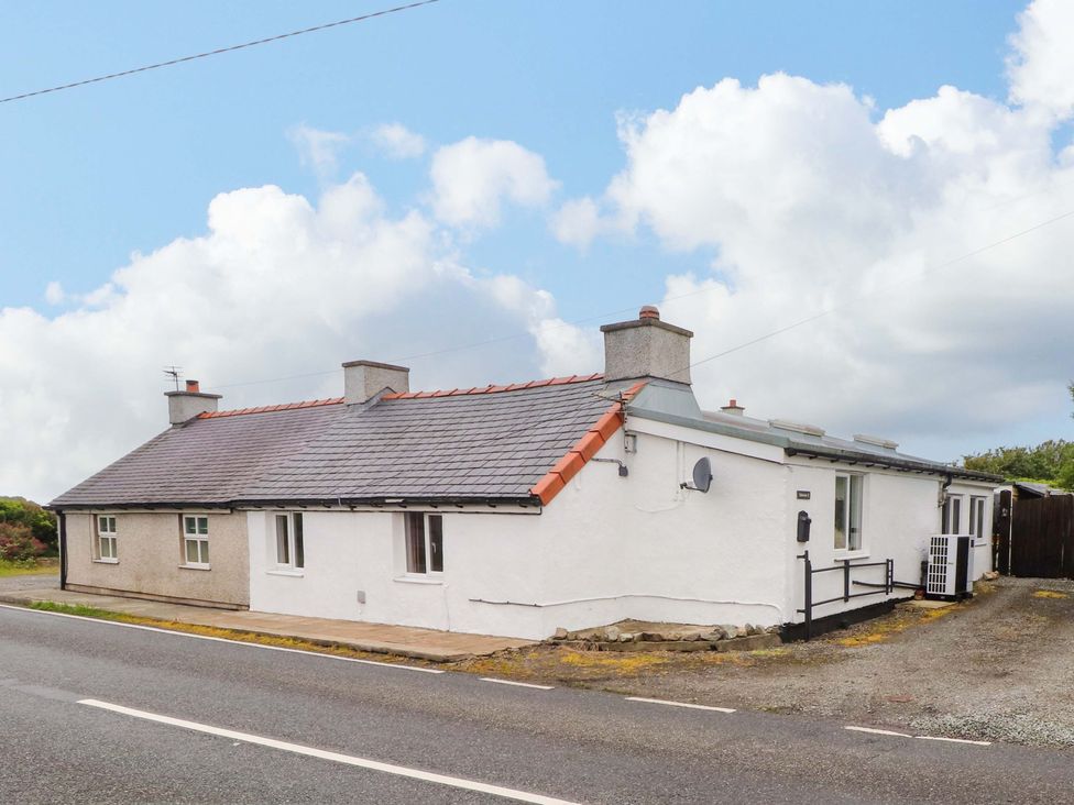 A house with a grey and white exterior and windows located at 2 Llainwen Ty Croes