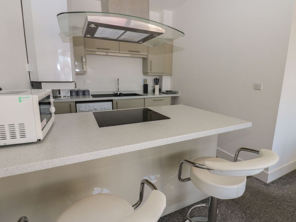 A kitchen with a microwave and stove at Harbour View in Whitehaven