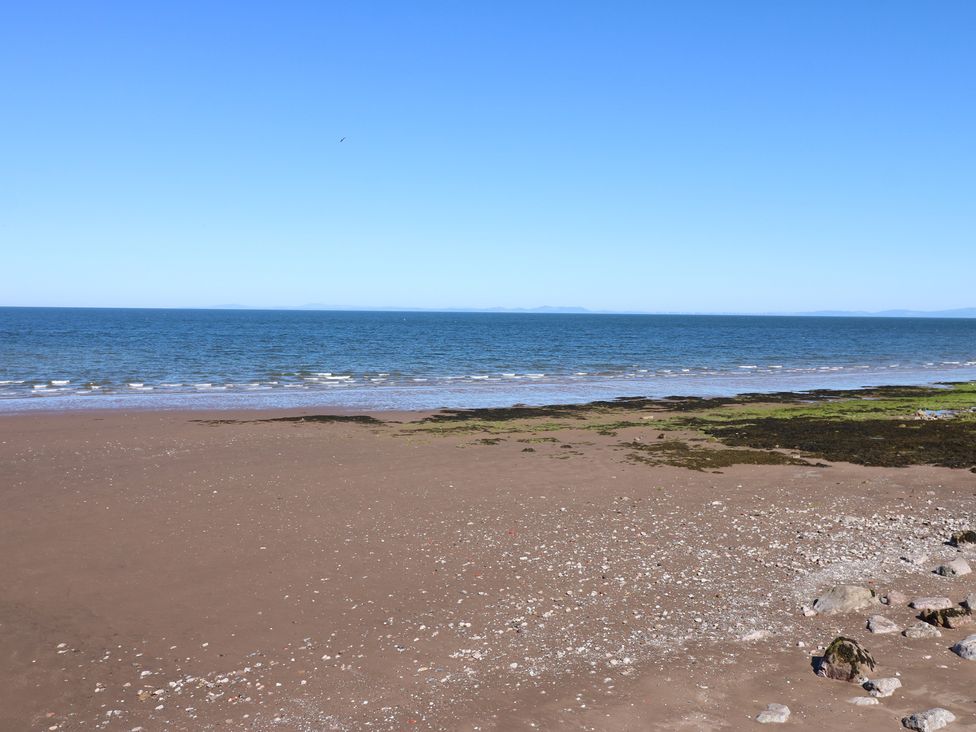 A beach with sand and sea at Harbour View in Whitehaven